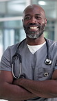 Doctor, happy and face of black man in hospital with crossed arms for medical service, career or job. Healthcare, professional and portrait of person with confidence for wellness, clinic and about us