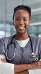 Nurse, happy and face of black woman in hospital with crossed arms for medical service, career or job. Healthcare, professional and portrait of confident person laugh for wellness, clinic or about us