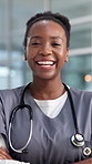 Nurse, laugh and face of black woman in hospital with crossed arms for medical service, career and job. Healthcare, professional and portrait of person with pride for wellness, clinic and about us