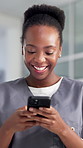 Black woman, nurse and phone with texting at hospital, laugh and lobby with low angle for notification. African person, smartphone and medical expert with mobile app, chat and social media at clinic