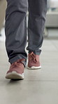 Feet, doctor and walking in hospital, lobby and career with healthcare services for wellness. Person, medical professional and shoes on floor with job, consulting and legs in hallway at clinic