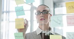 Business woman, sticky notes and writing on glass wall for strategy, link building and planning. SEO manager, employee and arrow to information in office for competitor analysis and market research