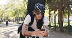 Sunglasses, phone and delivery man in city for cycling, eco friendly travel and search for gps. Sustainable transport, person and bicycle in urban town with tech, mobile app and courier service.