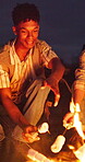 Man, friends and campfire with marshmallows at night for camping, cooking dessert and bonding together. People, roasting and bonfire for sweet treat, outdoor activity and social gathering in nature