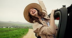 Happy woman, car and window with freedom for travel, adventure or outdoor journey in countryside. Excited, female person or passenger with hat in vehicle for holiday getaway or vacation in nature