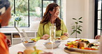 Eating, woman and laughing with dinner in home for funny conversation, social gathering or event. Bonding, happy people and food at dining table with comic story, brunch celebration and reunion party