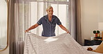Woman, blanket and tidy bed in home for morning routine, bedroom maintenance or cleanliness. Wake up, mature person or organize bedding in apartment for housework cleaning, domestic chores or hygiene