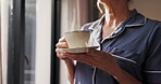 Thinking, senior and hands with coffee cup by window, morning inspiration and memory reflection. Peace, elderly and woman in retirement home with hot beverage, relax and nostalgia on weekend.