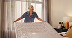 Woman, blanket and cleaning bed in home for morning routine, tidy bedroom and cleanliness. Wake up, mature person or organize bedding in house for housekeeping maintenance, domestic chores and habit