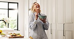 Dancing, senior woman and laughing in kitchen with food, happiness and energy from breakfast nutrition. Smile, meal prep and elderly person at home with fruit salad, morning snack and balanced diet.