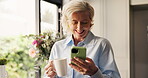 Laughing, old woman and phone in kitchen with coffee, internet comedy and scroll on social media. Tech, senior and happy female person in home with drink, funny video and entertainment on mobile app.