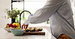 Cutting, fruit salad and hands of woman in kitchen of home for diet, health or nutrition. Breakfast, cooking and food with person chopping at counter in apartment for natural or organic meal prep