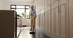 Chores, housework and sweeping with woman in kitchen of home for cleaning or responsibility. Broom, dust and maintenance with mature person in apartment for daily housekeeping or hygiene routine
