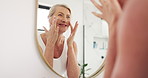 Bathroom, mirror and mature woman to check face for anti aging results, wellness and skincare. Morning routine, beauty and happy person with reflection for skin glow, health and grooming in home
