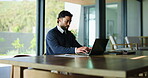 Business, man and typing in office with laptop, stress and deadline in board room. Serious, person and entrepreneur in workplace with technology, online research and problem solving for company.