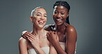 Face, friends and women with glow, skincare and laughing with healthy skin, mockup space and studio. People, diversity and humor for funny joke, gray background and happy for dermatology benefits