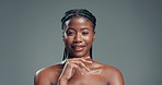 Black woman, face and beauty with skincare in studio for cosmetology on a gray background. Portrait, female person or African model with smile, makeup or glow up for cosmetics or shine on space