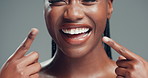Dental, woman or show teeth in studio with whitening results, alignment treatment or confidence. Cosmetics, mouth of person and laughing on gray background for palatal expanding, oral health or pride