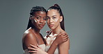 Face, embrace and women in studio, cream and dermatology with shine on grey background. People, space and friends with wellness, cosmetics and creme with beauty, hug and glow with facial treatment