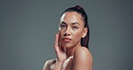 Skincare, serious and hands with face of woman in studio for aesthetic, self care and collagen glow. Dermatology, mockup space and beauty with female person on background for clear skin and hydration