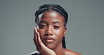 Skincare, serious and face of black woman in studio with health, beauty and facial glow. Confident, wellness and portrait of African female person with dermatology for cosmetics by gray background.