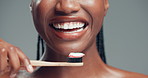 Dental health, toothbrush and mouth of black woman in studio with routine for fresh breath. Happy, toothpaste and African female person brushing teeth for oral care and hygiene by gray background.