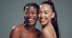 Laughing, women and hug in studio, skincare or friends with healthy skin, mockup space and cosmetics. People, diversity and humor for funny joke, gray background and happy for dermatology benefits
