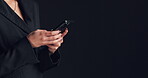 Online, employee and hands with smartphone, studio and communication for funding opportunity on web. Typing , message and person with mobile for investment, black background and mockup space or chat