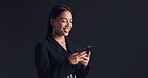 Laughing, businesswoman and texting with smartphone, studio and communication with contact on break. Mockup space, black background and person with mobile for chat, smile and reading funny message