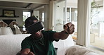 Man, VR headset and racing game on sofa for user experience, entertainment and virtual challenge. Gamer, black person and playing with 3D glasses in home for simulation driving contest and metaverse