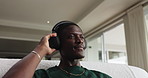 Relax, music and black man with headphones on sofa, streaming service and online sound in house. African person, audio and listening to radio in living room for chill, melody and hip hop beat in home