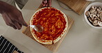 Kitchen, cooking and hands with dough, pizza or tomato sauce for flavor, culinary skills and cuisine. Handmade, food prep and process with ingredients for meal, above and person with recipe in house