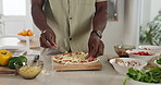 Hands, cooking and pizza in kitchen with mushroom in home, organic ingredients and meal prep for baking. Person, chef and food with cheese, cuisine or process with dough for recipe at apartment
