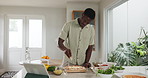 Black man, cooking and pizza in kitchen with cheese, tablet and online course with ingredients for meal. African person, food and tech with video, dough or virtual class on app for cuisine at house