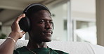 Relax, audio and black man with headphones on sofa, streaming service and online sound in house. African person, music and listening to radio in living room for melody, chill and hip hop beat in home