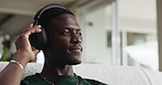 Relax, audio and black man with headphones in home, streaming service and online sound in house. African person, music and listening to radio in living room for melody, chill and hip hop beat on sofa