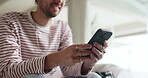 Hands, typing and man with smartphone, lounge and communication with contact, social media or online. Happy, texting and person with mobile for message, scroll and networking with tech on web or home