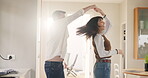 Happy, couple or dancing with spinning in home for anniversary celebration, bonding or radio song. Hug, people or rhythm with music playlist for healthy relationship, support or connection with flare