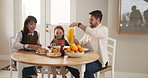 Girl, parents and happy with orange juice, breakfast and help with chat, care and love in home. People, mother and daughter child with dad, talk and bonding with drink for nutrition at family house