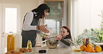 Home, mom and child with flour, baking and teaching muffin recipe to daughter, learning and bonding. Happy, woman and helping girl with dessert preparation, discussion and ingredients in kitchen
