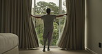 Back, woman and open curtain in bedroom to start day, waking up and morning routine for sunshine. Person, awake or sunlight with drapes of window for fresh air, check weather and garden view at house