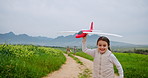 Airplane, nature and kid on farm with running, fun or vacation in countryside together. Outdoor, adventure and parents with child for playing with toy on ranch for holiday with family bonding.