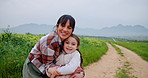 Farmer, hug and face of mom with daughter on countryside dirt road for sustainability. Agriculture, family or smile with girl child and single parent woman embracing outdoor for organic farming