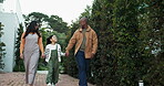 Smile, parents and walk with child in backyard with love, fresh air and bonding together at house. Happy, interracial family and holding hands with kid, explore neighborhood and connection outdoor