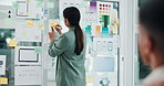 Business, woman and notes on glass in office with ux design, ui layout and interface planning. Person, writing and meeting with wireframe for user experience, review template and ideas for software
