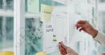 Hands, person and notes on glass in office with ux design, ui layout and interface planning. Staff, meeting and app icons with wireframe for user experience, review template and ideas for software