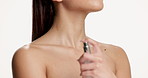 Perfume, beauty and body of woman in studio for fresh scent, smell or confidence with self care. Cosmetics, luxury fragrance and female person with spray bottle for aroma by white background.