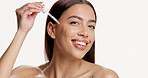 Happy woman, face and dropper for skincare in studio, essential oil and mockup space on white background. Person, model and product with dermatology benefits for cosmetics, serum and beauty in Mexico