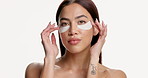 Woman face, eye patches or beauty mask, hydration product or facial treatment for wellness glow. Skincare, person touch or dermatology for dark circles, self care or space on white studio background.