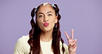 Woman, peace sign or face in studio with confidence, playful or laughing for positive energy. Gen z, student and gesture on mockup space with purple background, happy and pose for social media